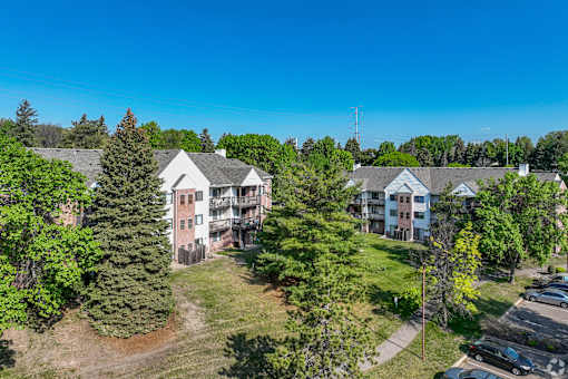 A sunny day in a residential area with houses and greenery.