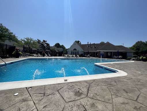 A large outdoor swimming pool with a 10-foot depth marker.