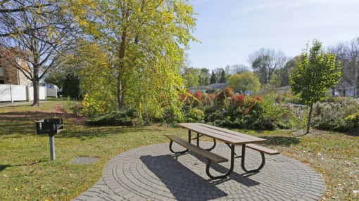 a picnic table and bench in a park