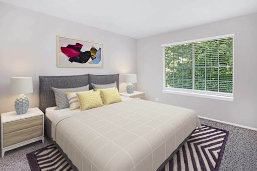 A bedroom with a large bed and a painting above it.