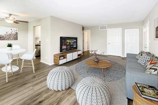 A living room with a white ceiling and a grey couch.