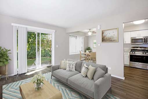 A living room with a grey couch and a wooden coffee table.