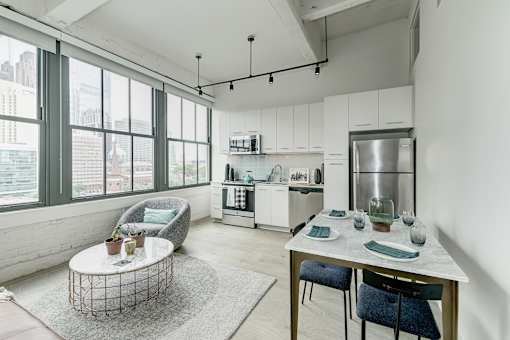 A modern kitchen with a dining table and chairs.at 1600 Callowhill, Philadelphia Pennsylvania