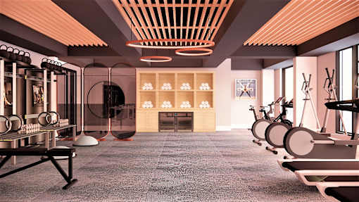 A modern gym with a variety of equipment including treadmills, stationary bikes, and weight machines.
