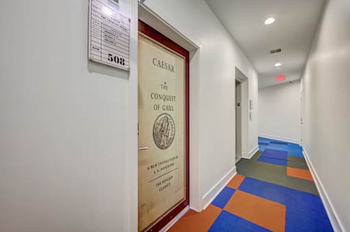 A hallway with a sign that says Caesar.