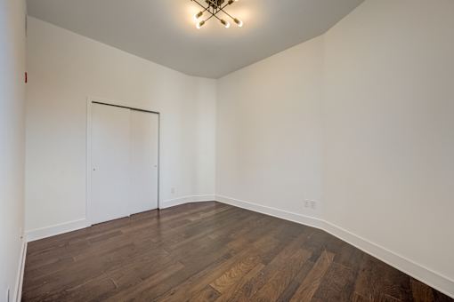 A room with wooden floors and a white door.