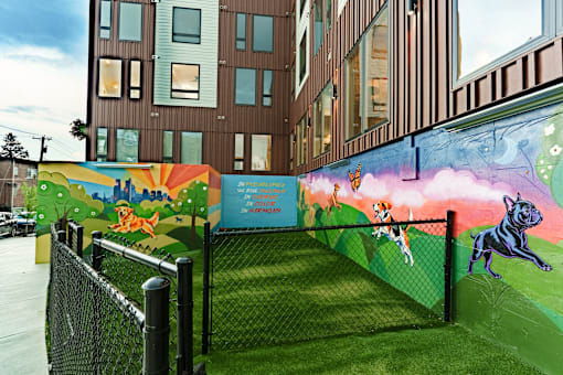 A mural of a dog and a cat painted on a wall.