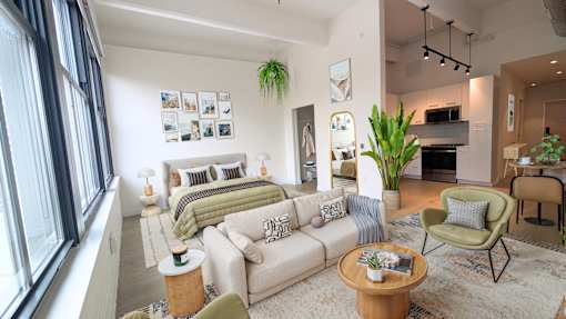 A modern living room with a large couch, a coffee table, and a fireplace. at 1600 Callowhill, Philadelphia, PA