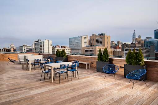 A rooftop patio with chairs and tables overlooking a city skyline.at 1600 Callowhill, Philadelphia