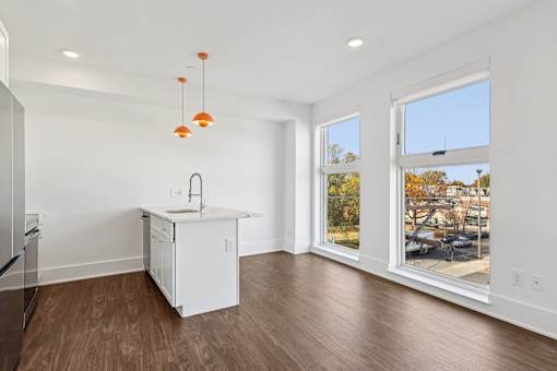 A kitchen with a white cabinet and a sink is shown.