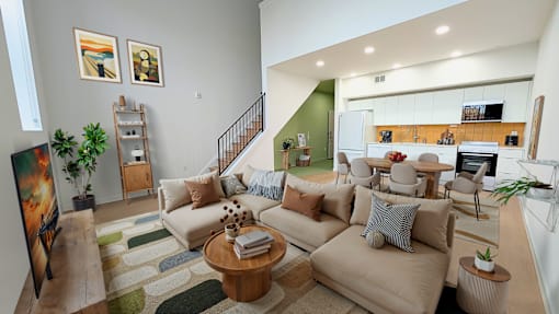 A living room with a couch, a coffee table, and a painting on the wall.