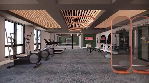 A gym with a row of treadmills and exercise equipment.