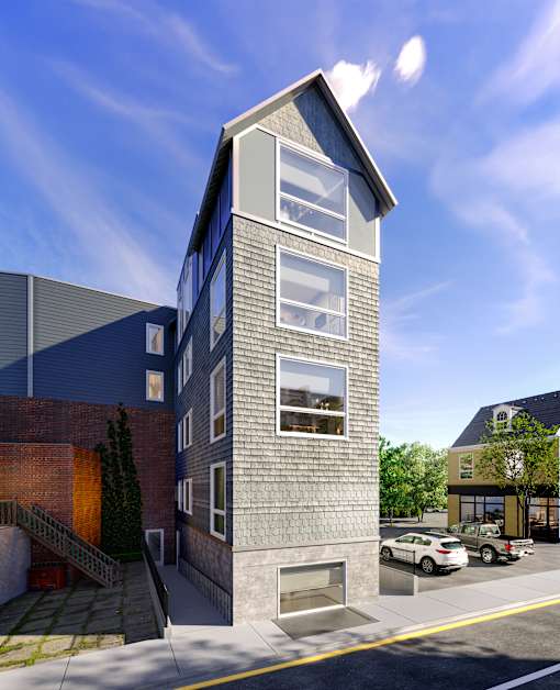 A modern building with a grey facade and a large window on the top floor.