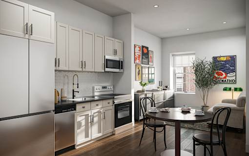 A modern kitchen with a dining table and chairs.