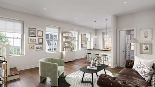 A living room with a brown leather couch, a green armchair, and a coffee table.