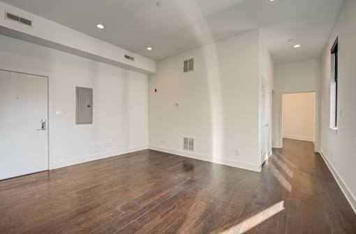 A room with a white door and a white wall.