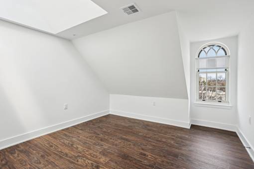 A room with a window and a skylight.