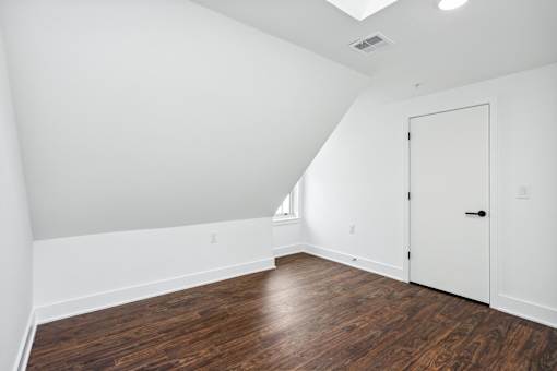 A room with a wooden floor and white walls.