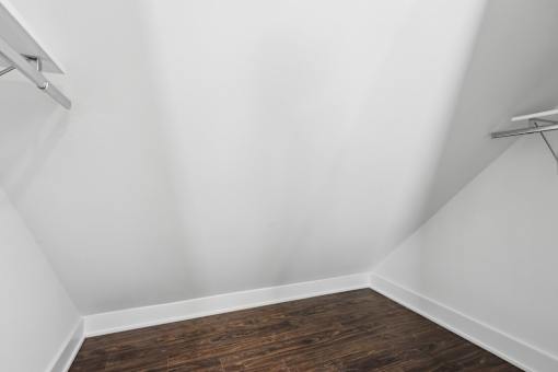 A room with white walls and wooden flooring.