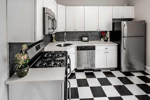 A black and white checkered floor in a kitchen.