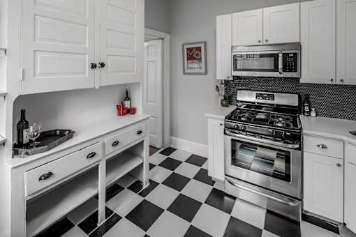 A black and white checkered floor in a kitchen.