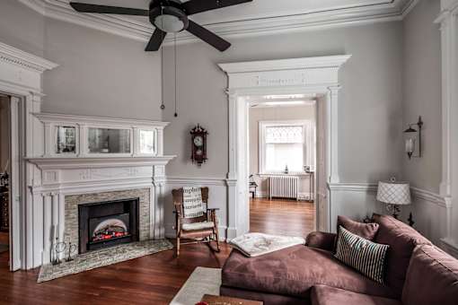 A living room with a fireplace and a couch.