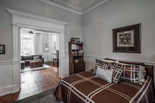 A bedroom with a large bed and a window.