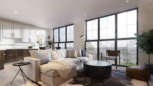 A modern living room with a large couch, a coffee table, and a view of the city.