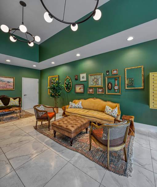 A living room with a green wall and a brown sofa.