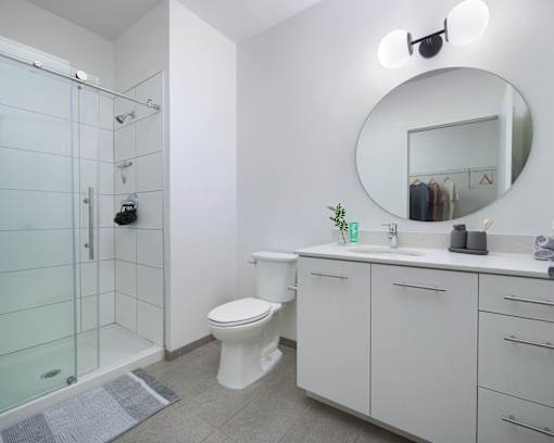 A bathroom with a toilet, sink, and mirror. at 1600 Callowhill, Philadelphia, PA