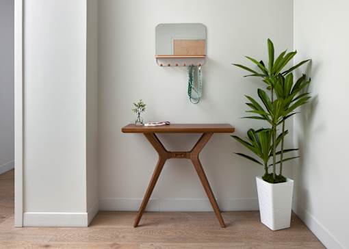 A small table with a plant on the right and a mirror on the wall. at 1600 Callowhill, Philadelphia, PA