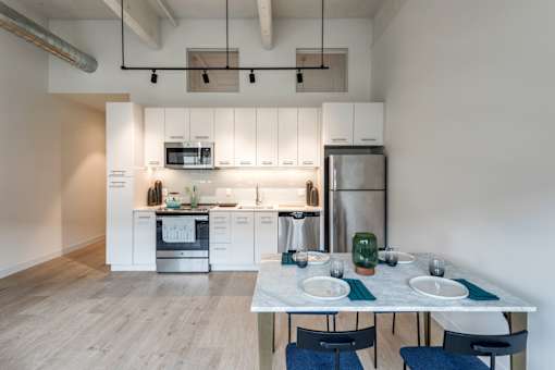 A modern kitchen with a dining table set for two.at 1600 Callowhill, Pennsylvania