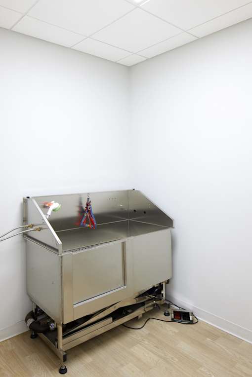A metal table with a white cloth and some objects on it.