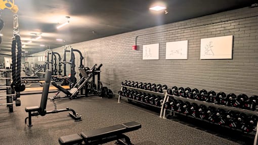 A gym with weights and exercise equipment.