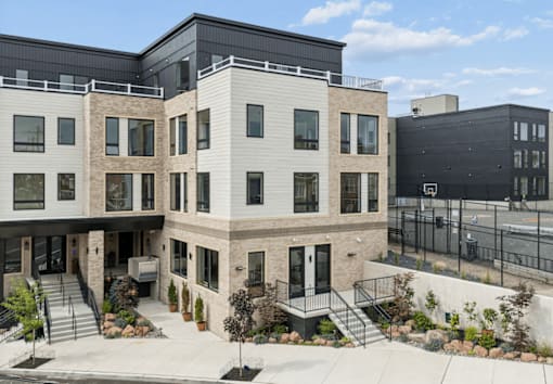 A modern building with a black fence in front.