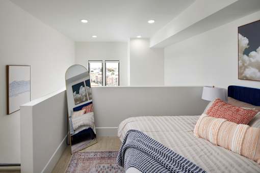 A bedroom with a bed, pillows, and a window. at 23 West Apartments, Philadelphia, PA