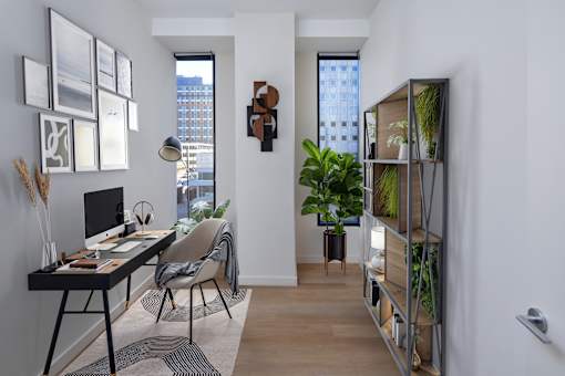 A room with a desk, chair, and a window.