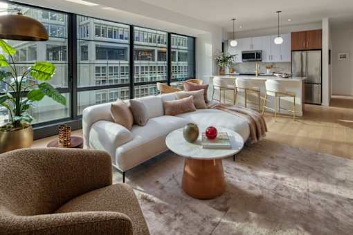 A modern living room with a large window overlooking a cityscape.