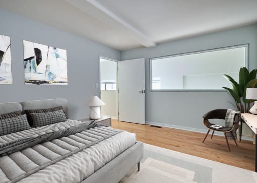 a living room with a couch and a chair and a window