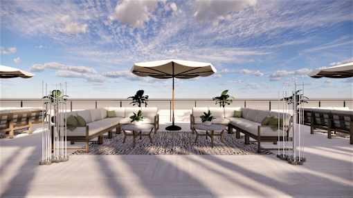 A white patio with a large umbrella and chairs.