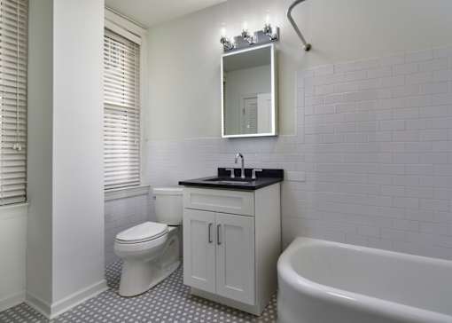 A white toilet sits next to a sink in a bathroom.