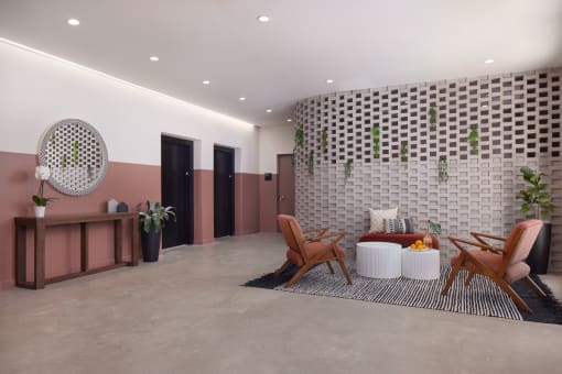 a lobby with a couch and chairs and a checkerboard wall