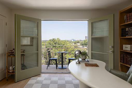 A small table with a globe on it is in the middle of a room at The PARKER on E Mulberry Apartments, San Antonio