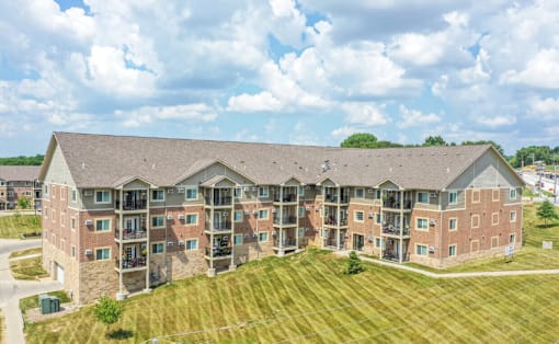an aerial view of an apartment building with a grassy area in front of it