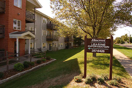 a sign in front of an apartment building