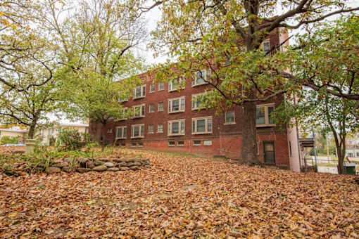a red brick building with trees in front of it
