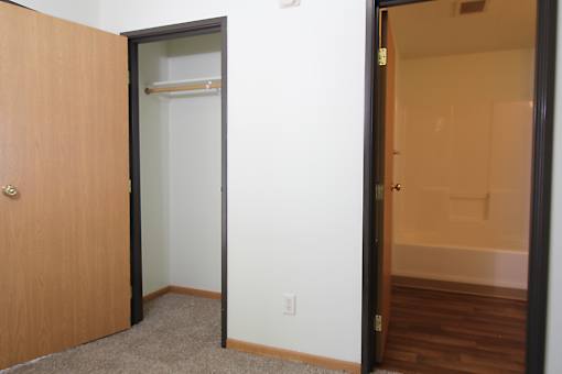 an open door to a bathroom with a shower and bathtub