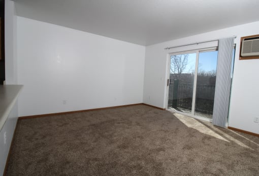 a living room with a door to a balcony