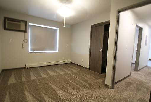 an empty room with a whiteboard on the wall