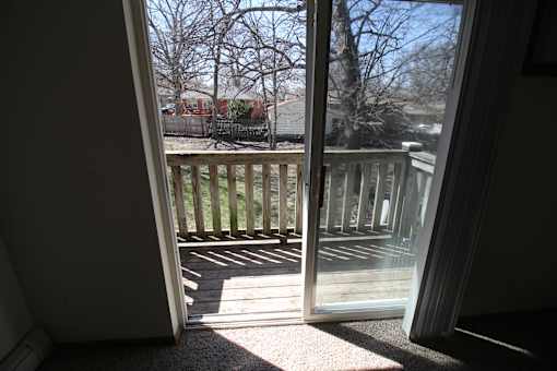 a sliding glass door with a view of the deck